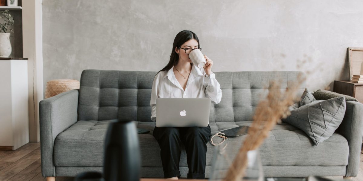 woman-drinking-coffee-while-working-with-laptop-4050289