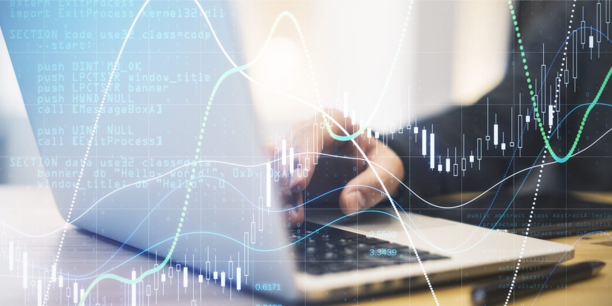 Forex trade market analysis concept with businessman working on laptop and digital screen with financial chart with diagram. Double exposure